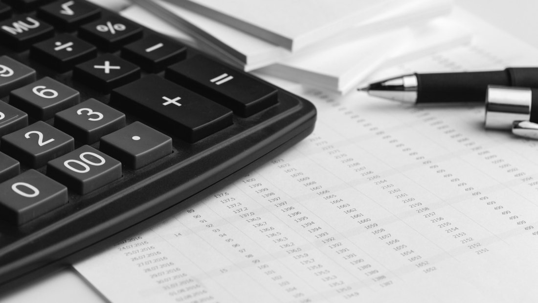 Business still life with calculator on table in office.