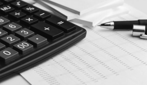 Business still life with calculator on table in office.