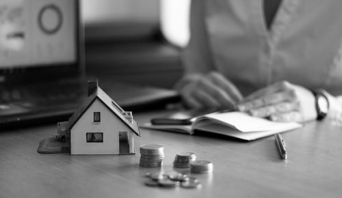 A closeup shot of a person thinking of buying or selling a house