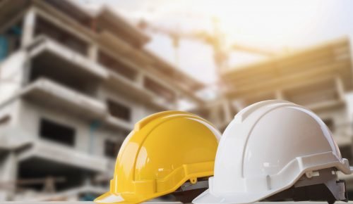 yellow and white helmet safety in construction site